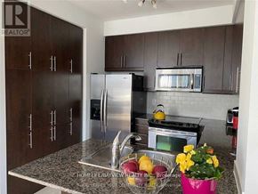 Toronto (Willowdale East) condo for rent - A kitchen with a refrigerator, stove, and microwave.