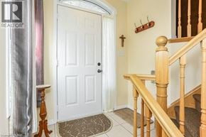 Cambridge townhouse for rent - A white door is in a hallway with a wooden banister.