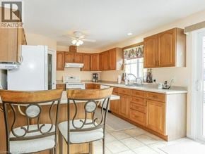 Cambridge townhouse for rent - A kitchen with wooden cabinets and a white fridge.