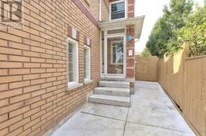 Brampton (Fletcher's West) apartment for rent - A brick house with a porch and a fence.