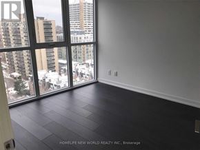 Toronto (Mount Pleasant West) condo for rent - A room with a view of the cityscape through large windows.