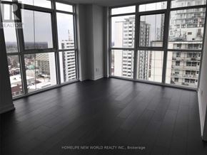 Toronto (Mount Pleasant West) condo for rent - A room with large windows overlooking a cityscape.