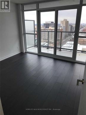 Toronto (Mount Pleasant West) condo for rent - A room with a view of the city through large windows.