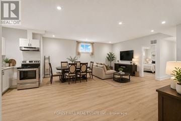 Toronto (Englemount-Lawrence) apartment for rent - A modern living room with a dining table and chairs.