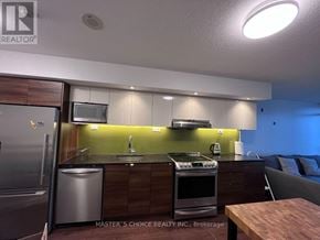 Toronto (Bayview Village) condo for rent - A kitchen with a refrigerator, sink, and stove.