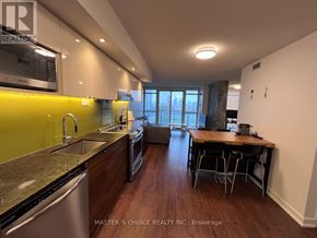 Toronto (Bayview Village) condo for rent - A kitchen with a dining table and chairs in the middle of the room.