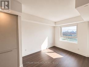 Toronto (North St. James Town) condo for rent - A room with a window overlooking a cityscape is for sale.