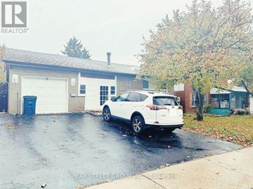 Toronto (Agincourt South-Malvern West) apartment for rent - A white car is parked in front of a garage.