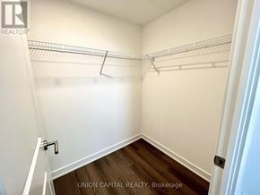 Toronto (Cliffcrest) condo for rent - A white closet with a wooden floor and a white door.