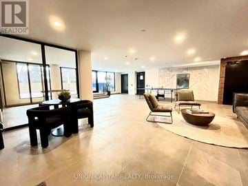 Toronto (Cliffcrest) condo for rent - A spacious living room with a black table and chairs.