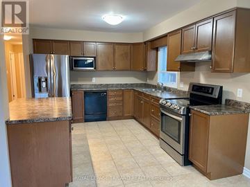 London East (East A) apartment for rent - A kitchen with wooden cabinets and a granite countertop.