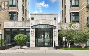 Markham (Unionville) condo for rent - The front of a building with a large glass door and a sign that reads "HOME LANDMARK REALTY INC.".