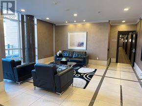 Markham (Unionville) condo for rent - A living room with a black couch and a painting on the wall.