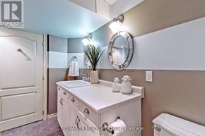 Markham (Cornell) apartment for rent - A bathroom with a white sink and a round mirror.