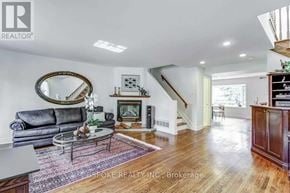 Toronto (Kingsway South) apartment for rent - A living room with a grey couch, a coffee table, and a staircase.
