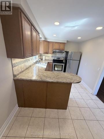 Mississauga (Port Credit) multi-family for rent - A kitchen with brown cabinets and a granite countertop.