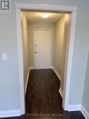 Mississauga (Port Credit) multi-family for rent - A hallway with a white door and a light on the ceiling.