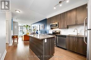 Toronto (Islington-City Centre West) condo for rent - A modern kitchen with a large island and stainless steel appliances.