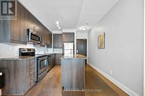 Toronto (Islington-City Centre West) condo for rent - A modern kitchen with stainless steel appliances and wooden cabinets.