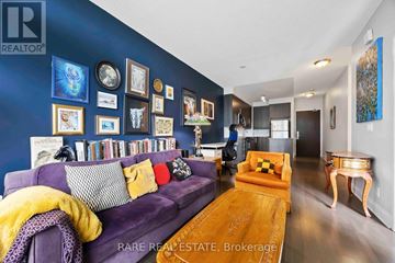 Toronto (Islington-City Centre West) condo for rent - A living room with a purple couch and a wooden coffee table.