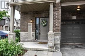 Hamilton (Ancaster) townhouse for rent - A house number 53 with a grey door and a wreath on it.