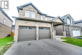 Thorold (Hurricane/Merrittville) apartment for rent - A house with a grey garage door is for sale.