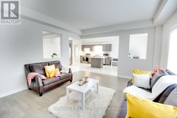 Thorold (Hurricane/Merrittville) apartment for rent - A living room with a brown leather couch and a white coffee table.