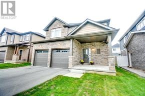 Thorold (Hurricane/Merrittville) apartment for rent - A large house with a grey garage door is for sale.