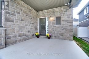 Thorold (Hurricane/Merrittville) apartment for rent - A stone wall with a door and two potted plants.