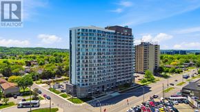 Hamilton (Riverdale) condo for rent - A large, modern apartment building is the focal point of a bustling city intersection.