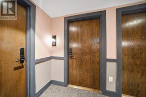 Hamilton (Riverdale) condo for rent - A hallway with wooden doors and a sign that says REALTOR.