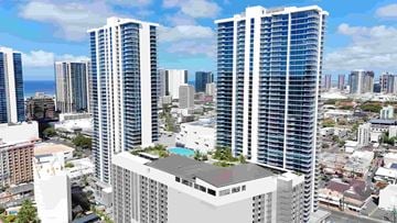 Honolulu apartment for rent - Two tall buildings with a pool on the roof in the middle of a city.