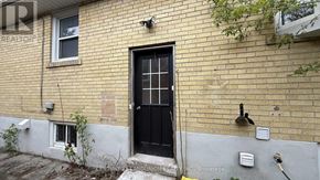 Richmond Hill (Crosby) apartment for rent - A black door is on the side of a brick building.