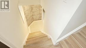 Richmond Hill (Crosby) apartment for rent - A staircase with wooden steps and white walls.