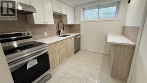 Richmond Hill (Crosby) apartment for rent - A kitchen with white cabinets and a black stove top oven.