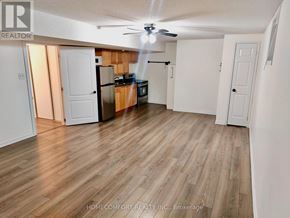 Barrie (Painswick South) apartment for rent - A well lit kitchen with wooden floors and white walls.
