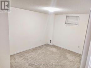 Barrie (Painswick South) apartment for rent - A room with a carpeted floor and a window with blinds.
