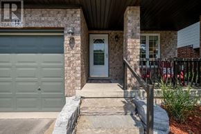 Halton Hills (Georgetown) apartment for rent - A house with a grey garage door and a stone wall.