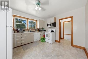 Halton Hills (Georgetown) apartment for rent - A kitchen with white cabinets and a window.