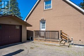 Halton Hills (Georgetown) apartment for rent - A house with a brown garage door and a wooden deck.