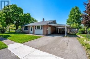 Halton Hills (Georgetown) apartment for rent - A house with a driveway and a tree in front.
