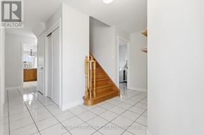 Caledon (Bolton East) apartment for rent - A white hallway with a wooden staircase.