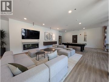 North Vancouver apartment for rent - A living room with a fireplace and a television mounted on the wall.
