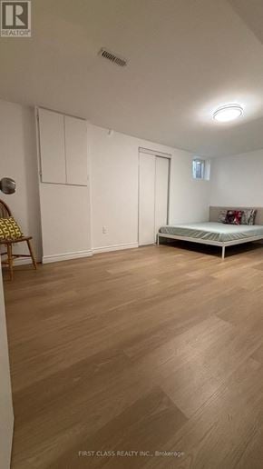Toronto (Agincourt North) apartment for rent - A bedroom with a bed, chair, and wardrobe.