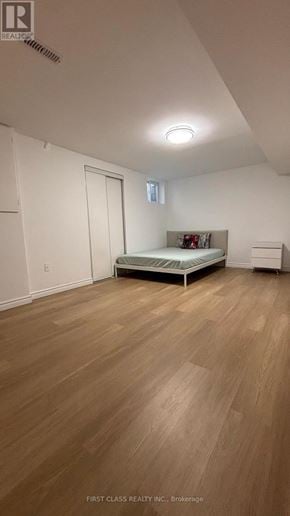 Toronto (Agincourt North) apartment for rent - A bedroom with a bed, nightstand, and a window.