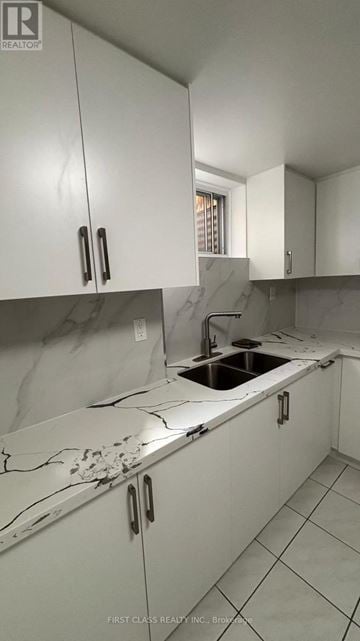 Toronto (Agincourt North) apartment for rent - A kitchen with white cabinets and a marble countertop.