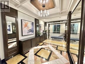 Toronto (Banbury-Don Mills) condo for rent - A hallway with a marble floor and a chandelier.