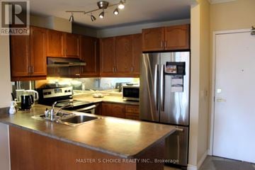 Toronto (Willowdale East) condo for rent - A kitchen with wooden cabinets and stainless steel appliances.