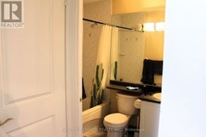 Toronto (Willowdale East) condo for rent - A white toilet sits in a bathroom next to a white door.