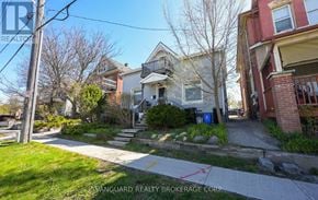 Barrie (Codrington) duplex for rent - A street view of a residential area with houses and a clear sky.